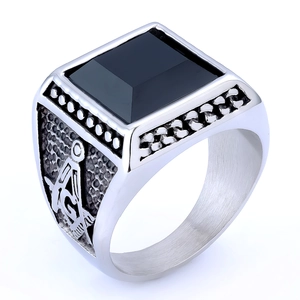 Detail of vintage stainless steel masonic ring with black gemstone and G compass emblem