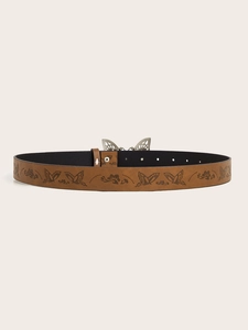 Detail of vintage brown leather belt with floral embossing and silver butterfly buckle