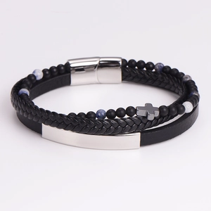 Detail of multi-layer leather bracelet featuring blue beads and a cross pendant
