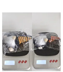 Weight display of Halloween gnome plush toy on an electronic scale showing 26g and 27g