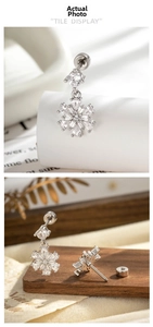 Macro detail of snowflake stud earring with zircon stones and screw back flat closure