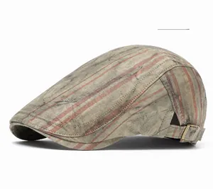 Detail of military green striped flat cap showing twill fabric and metal adjustable buckle