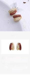 Detailed view of brown enamel and zircon pea-shaped earrings with 925 silver needles