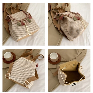 Detail of straw backpack showing colorful tassels, drawstring closure and woven texture