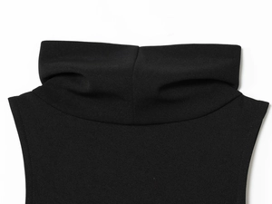 Detailed close-up of a black mock neck dress showing fabric texture and stitching