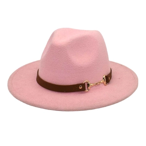 Detail of pink wool fedora hat featuring a brown band with a gold horsebit buckle