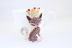 Detailed close-up of a fox keychain pendant featuring crystals and a golden crown