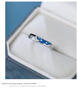 Close-up of S925 silver ring with dark blue enamel star and moon in a gift box