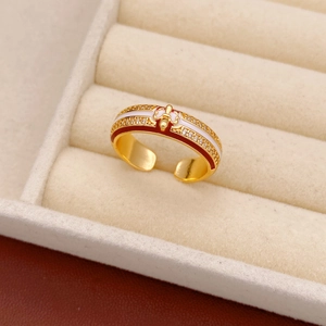 Detailed macro view of 18k gold plated enamel ring with sparkling zircon in a beige jewelry box