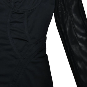 Close-up of black long sleeve jumpsuit showing mesh sleeve stitching and fabric texture