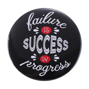Round tinplate badge with failure is success in progress quote and gamepad style design