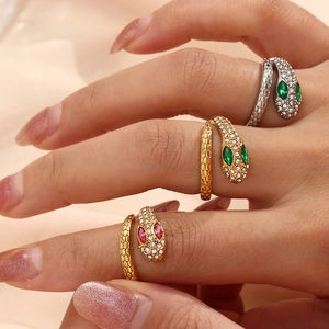 Three crystal-encrusted snake rings in gold and silver finish with adjustable bands