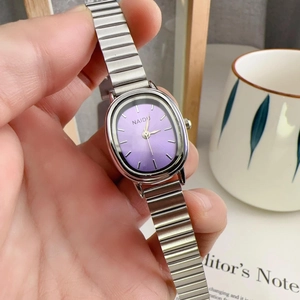 Detail of silver alloy stretch band watch with purple oval dial and gold markers