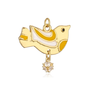 Detailed macro view of a gold bird pendant with yellow enamel and a zircon ball drop