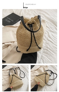 Detail of beige paper straw bucket bag featuring black leather straps and drawstring closure