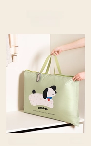 Close-up of a large green storage bag with cartoon dog pattern and reinforced handles
