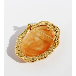 Vintage oval cameo relief brooch and necklace pendant in gold with orange marble finish