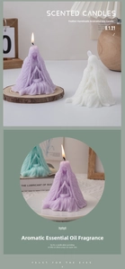 Detail view of handmade feather-shaped person scented candles in purple and white wax