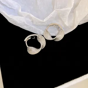 Minimalist silver twisted hoop earrings with delicate textured metal dots for women