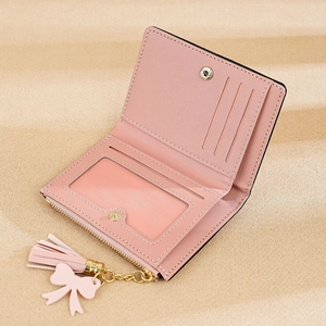 Pink bifold wallet detail showing card slots, ID window, and zipper pocket with tassel