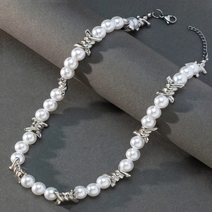 Detailed view of hip hop necklace with white pearls and silver braided metal links