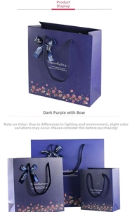 Detail of luxury dark purple gift bag with blue ribbon bow and elegant floral patterns