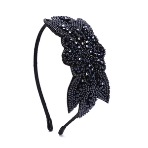 Vintage bohemian black beaded headband with intricate floral rhinestone design on white background
