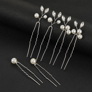 Detail view of 6 silver bridal hair pins with marquise pearls and crystal leaf designs