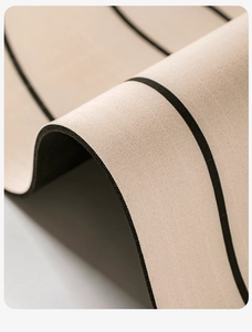 Macro view showing the flexible dual-layer structure and wood grain texture of the bath mat