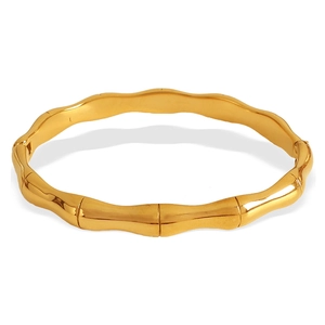 Polished golden bamboo style stainless steel bangle with a minimalist segment design