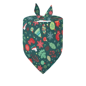 Detailed view of dark green Christmas pet bandana featuring festive tree and snowflake patterns