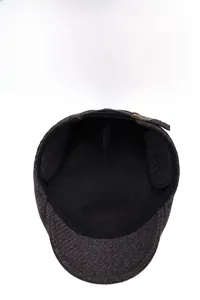 Detail view of winter beret cap showing thick fleece lining and foldable ear flaps
