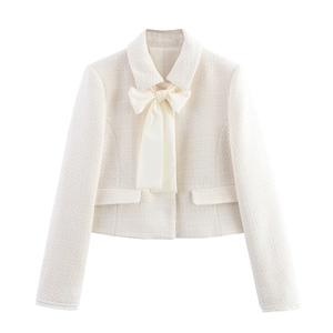 Elegant off-white tweed two-piece set featuring a cropped jacket with a large bow detail