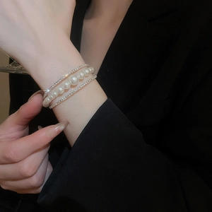 Detail of multi-layer silver bracelet with gradient pearls and sparkling zircons