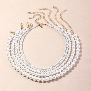 Detailed comparison of five layered white faux pearl necklaces with gold lobster clasps