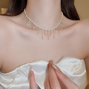 Elegant gold-plated pearl fringe choker necklace featuring delicate cascading tassel details