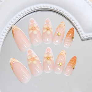 Sunset orange gradient press-on nails with 3D floral, starfish and pearl accents