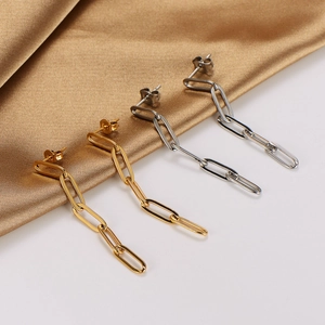 Minimalist stainless steel long chain link earrings in gold and silver on silk background