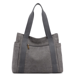 Minimalist grey canvas tote bag with side pockets and front zipper for daily commute