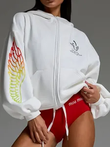 Close-up of white hoodie featuring a vibrant gradient wing print and thick fabric detail