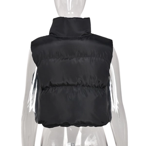 Rear view of black puffer vest featuring stand collar and quilted texture on model