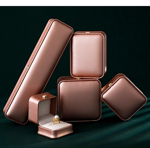 Detailed macro shot of stacked rose gold jewelry boxes for necklaces and rings