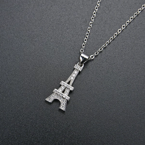 Macro shot of silver Eiffel Tower pendant with sparkling CZ stones on a fine chain