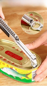 Macro shot of stainless steel can opener tool with black grip lifting a metal ring pull