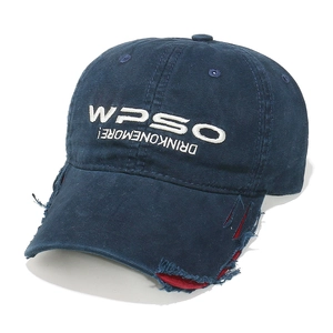 Detailed shot of distressed baseball cap brim with red layers and white embroidery