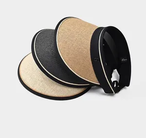 Detail of stacked UV straw hats in beige, grey, and natural with UPF50+ sun labels