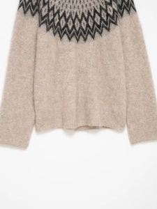 Detail of oatmeal knit sweater showing fuzzy alpaca texture and Nordic jacquard pattern