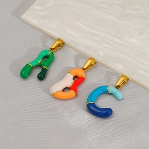 Detail of colorful enamel A, B, and C letter pendants with polished gold metal plating