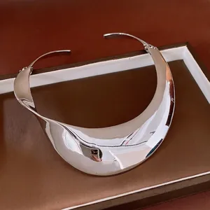 Polished silver wide metal collar necklace with a minimalist distorted luxury design