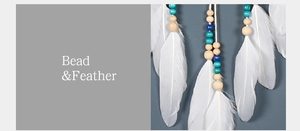 Detail of white feathers and colorful wooden beads on a Bohemian evil eye dream catcher